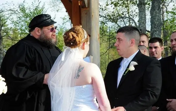 couple holding hands while saying wedding vows