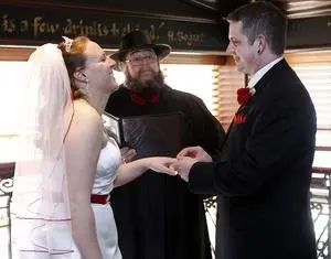 groom placing ring on bride's finger